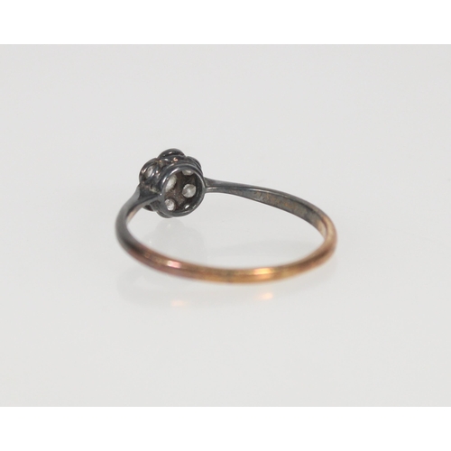 554 - Gold and diamond daisy cluster ring, gold hallmark rubbed, size U, 2.0g.