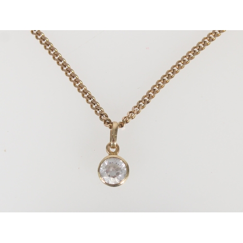 555 - 9ct gold and white stone round pendant on a 9ct gold chain, 6.3g.