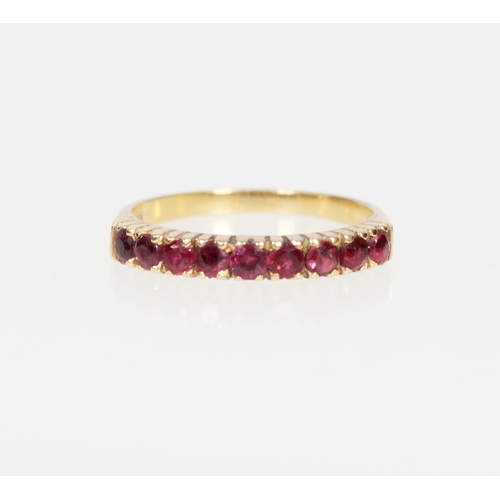 561 - 18ct gold and nine stone ruby ring, size P, 2.5g.