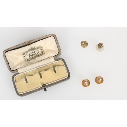 569 - Two 9ct gold button studs, 1.9g, together with two base metal studs in Harrods of London box.