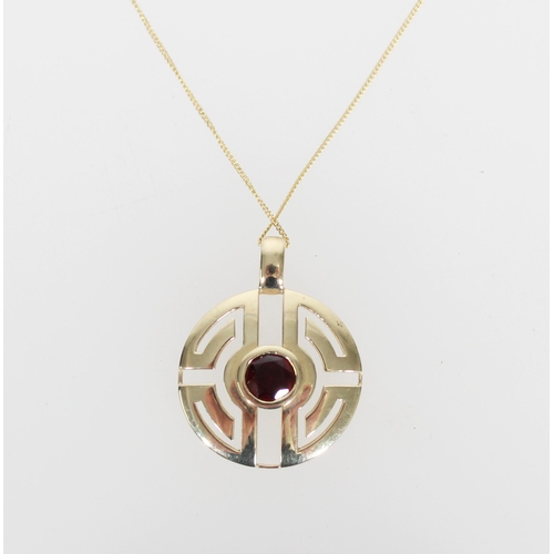 579 - 9ct gold fretwork pendant set with round garnet on 9ct gold chain, 2.4g.