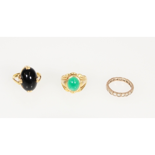 610 - Three yellow metal gem set rings.