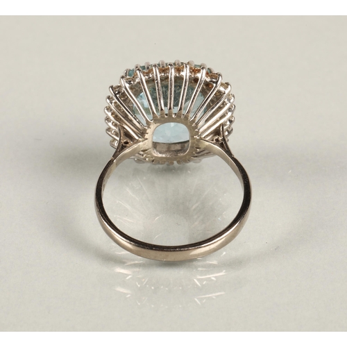 51 - Aquamarine and diamond dress ring, cushion shaped aquamarine with a border of small diamonds on 18ct... 