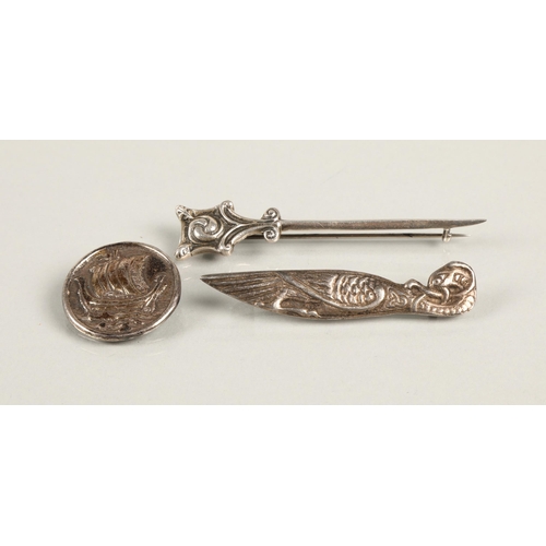 96 - Three assorted Alexander Ritchie Designed silver brooches, Norse boat, Zooamorphic bird and Celtic k... 