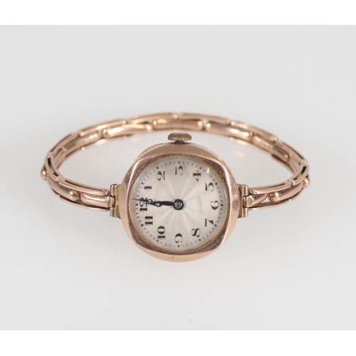 659 - 9ct gold cased wristwatch on plated extender bracelet.