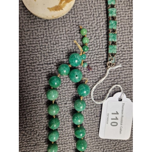 110 - Loose strands of polished green gemstone beads, white metal bracelet set with carved green plaques, ... 