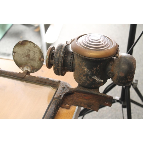 132 - Automobilia interest, a 1920s motor car windscreen and headlamps, the tax disc dated 1929, possibly ... 