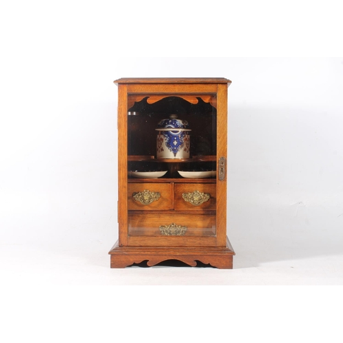 15 - Edwardian oak cased smoker cabinet with glazed front, 43cm high.