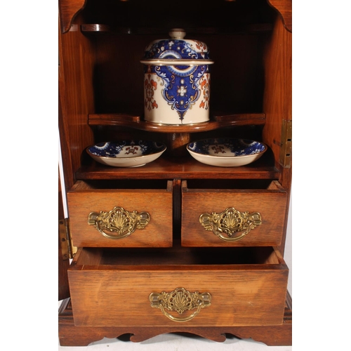 15 - Edwardian oak cased smoker cabinet with glazed front, 43cm high.