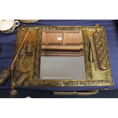 29 - Brass framed wall mirror with attached brush and bells, 44cm wide.