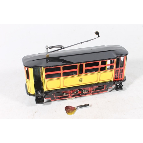 311 - Three tinplate aluminium clockwork models to include a motorcycle and sidecar, a tram car and an aer... 