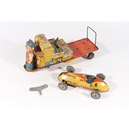 323 - British made tinplate clockwork model of a baggage handler with trolley and a British made clockwork... 