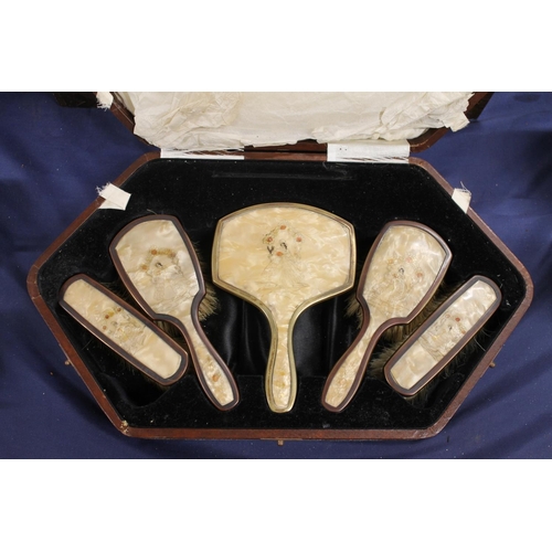 52 - Enamel backed dressing table set.