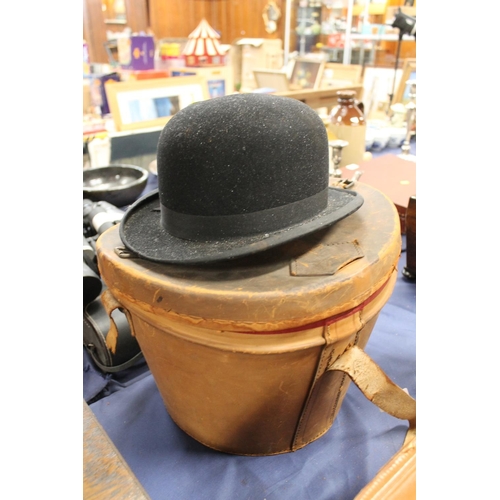 53 - Top hat in original leather hat box and a bowler hat.