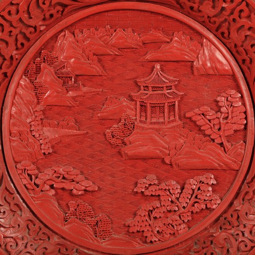 36 - Chinese cinnabar lacquered plate, relief decorated with Chinese garden, 25cm diameter.