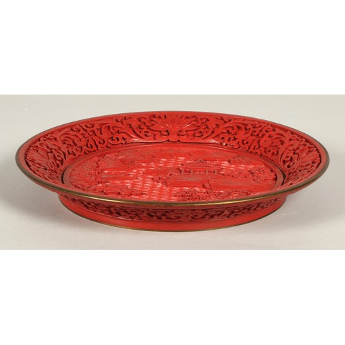 36 - Chinese cinnabar lacquered plate, relief decorated with Chinese garden, 25cm diameter.