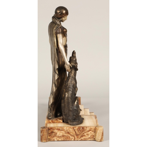 219 - After Georges Van De Voorde, Art Deco silvered and bronzed metal figure group, modelled as a lady wi... 