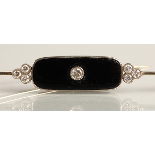 54 - Art Deco 18ct white gold diamond bar brooch, 0.2 carat diamond set in black onyx flanked by a trio o... 