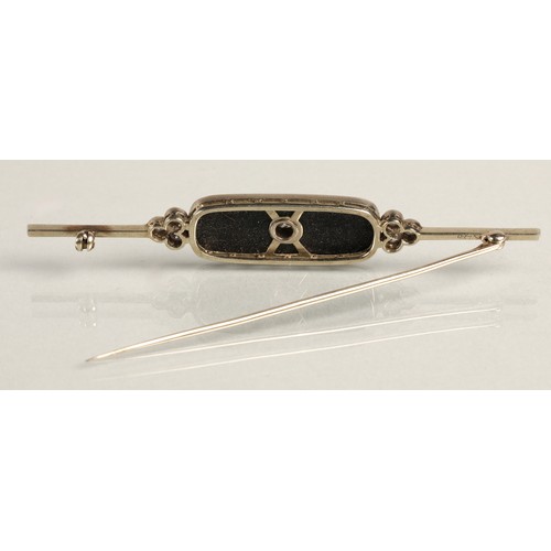 54 - Art Deco 18ct white gold diamond bar brooch, 0.2 carat diamond set in black onyx flanked by a trio o... 