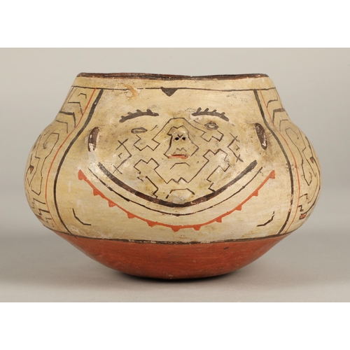 18 - Shipibo terracotta pottery bowl, 20th C, squat form, two faces with protruding features on opposite ... 