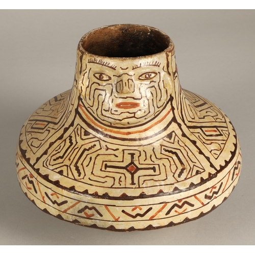 19 - Shipibo terracotta pottery vessel, 20th C, geometric patterns in brown and red surround a face with ... 