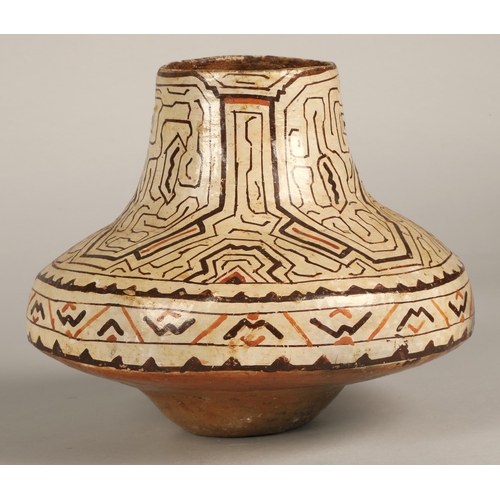 19 - Shipibo terracotta pottery vessel, 20th C, geometric patterns in brown and red surround a face with ... 