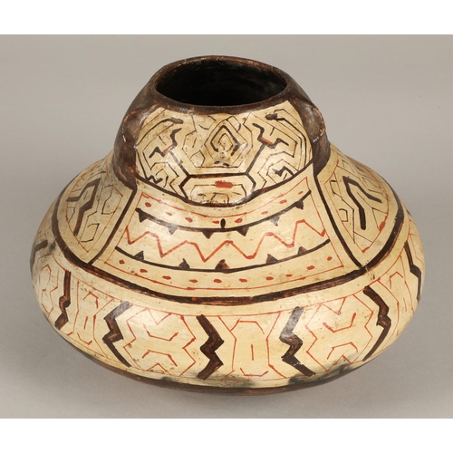 21 - Shipibo terracotta pottery vessel, 20th C, geometric patterns in brown and red surround a face with ... 