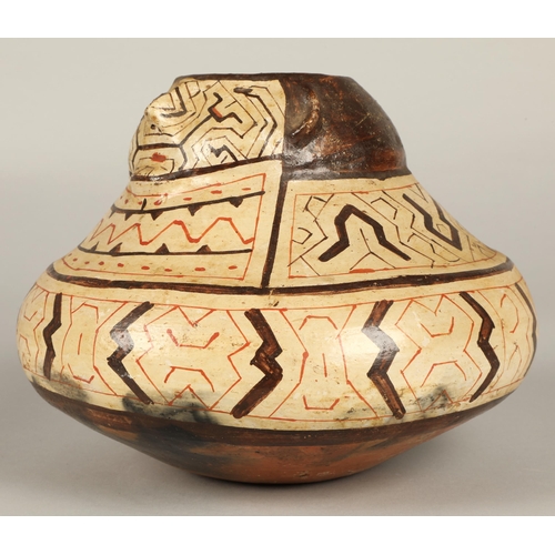 21 - Shipibo terracotta pottery vessel, 20th C, geometric patterns in brown and red surround a face with ... 