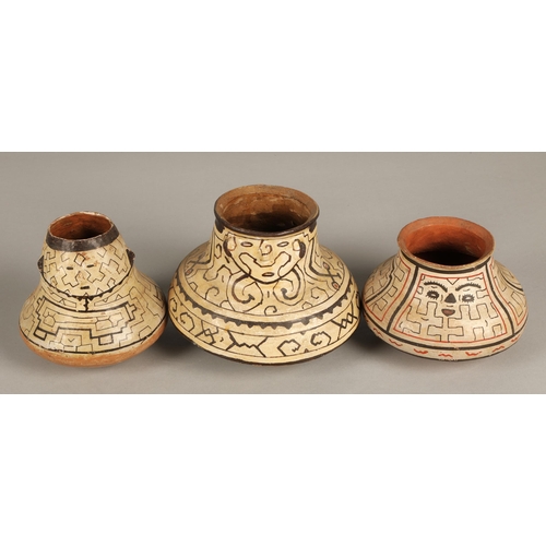 23 - Three Shipibo terracotta pottery vessels, 20th C, squat form, two with protruding facial features, d... 