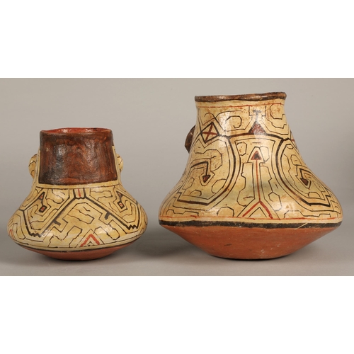 25 - Two Shipibo terracotta pottery vessels, 20th C, geometric patterns in brown and red surround faces w... 