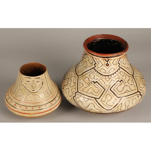 26 - Two Shipibo terracotta pottery vessels, 20th C, geometric patterns in brown and red on both, the sma... 