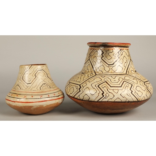 26 - Two Shipibo terracotta pottery vessels, 20th C, geometric patterns in brown and red on both, the sma... 