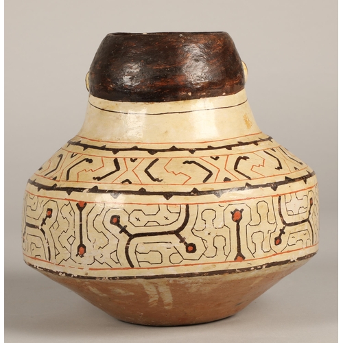 27 - Shipibo terracotta pottery vessel, 20th C, geometric patterns in brown and red surround a face with ... 