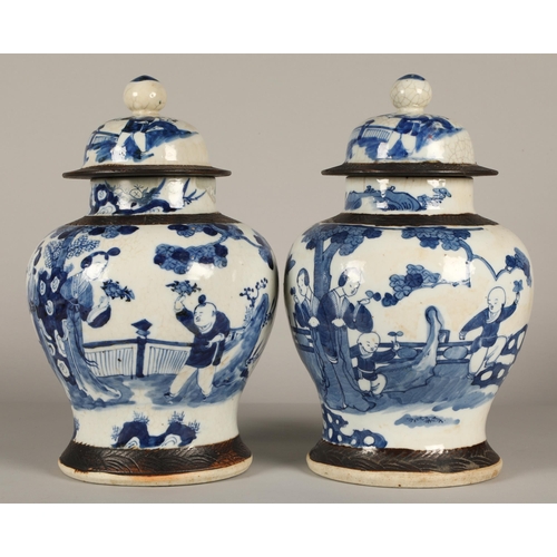 34 - Pair of Chinese glazed blue and white vases with covers, decorated with figures in a garden, 36cm hi... 