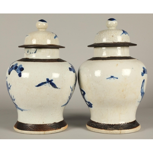 34 - Pair of Chinese glazed blue and white vases with covers, decorated with figures in a garden, 36cm hi... 