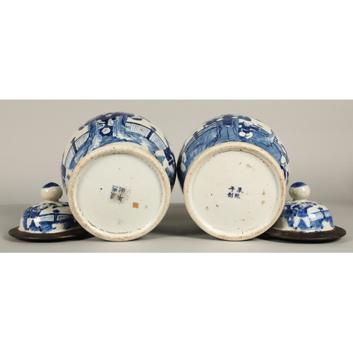 34 - Pair of Chinese glazed blue and white vases with covers, decorated with figures in a garden, 36cm hi... 