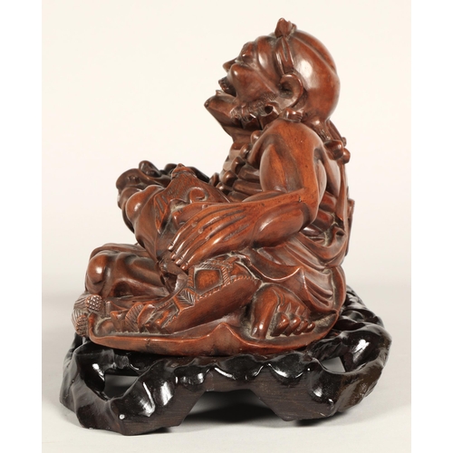 38 - Japanese root carving of Deity with dog of foo, 39cm long, 21cm high