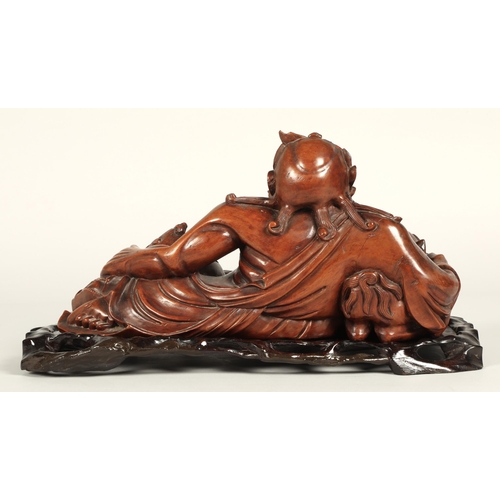 38 - Japanese root carving of Deity with dog of foo, 39cm long, 21cm high