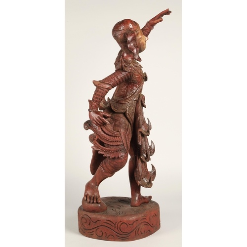 39 - Carved hardwood Thai dancing figure,75cm high.