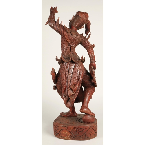 39 - Carved hardwood Thai dancing figure,75cm high.