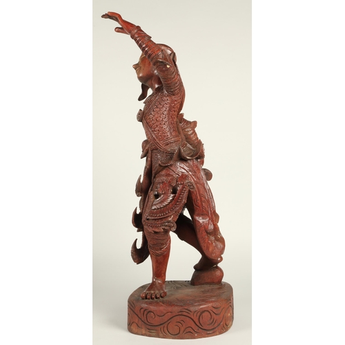 39 - Carved hardwood Thai dancing figure,75cm high.