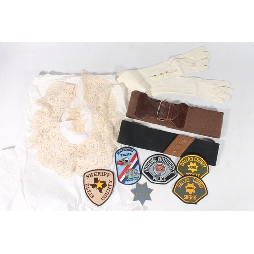 100 - American cloth sheriff and police badges, vintage evening gloves, and vintage belts.