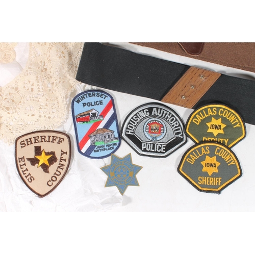 100 - American cloth sheriff and police badges, vintage evening gloves, and vintage belts.