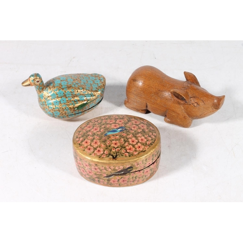 109 - Carved wooden model of a pig and two Indian lacquered boxes.