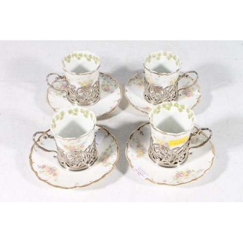 112 - Four Royal Vienna porcelain chocolate cups in hallmarked silver cup holders, and saucers.