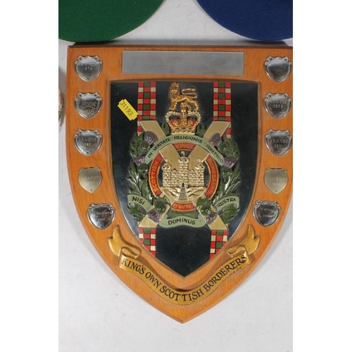 116 - Kings Own Scottish Borderers regimental plaque and school caps.