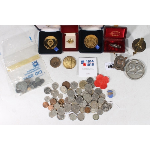 117 - Coins, medallions, cap badges, Victorian brass cup weights, a silver bear brooch, etc.