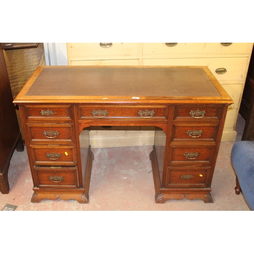 694 - Early 20th century kneehole desk with leather skiver,.