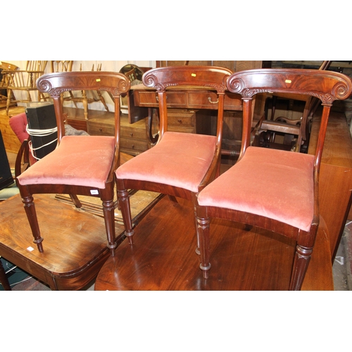 699 - Three late Victorian mahogany scroll back dining chairs.