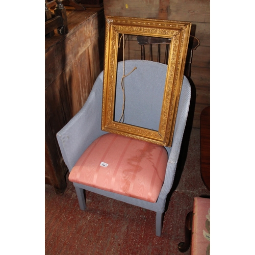 746 - Lloyd Loom style armchair and a gilt frame.